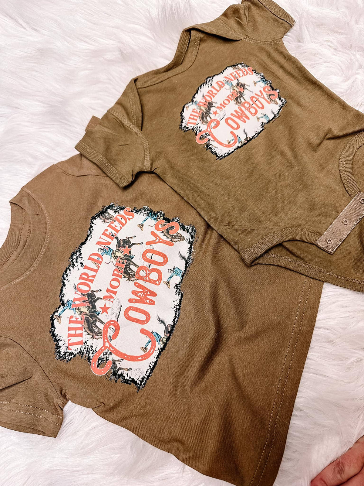 “The World Needs More Cowboys” Baby Onesie